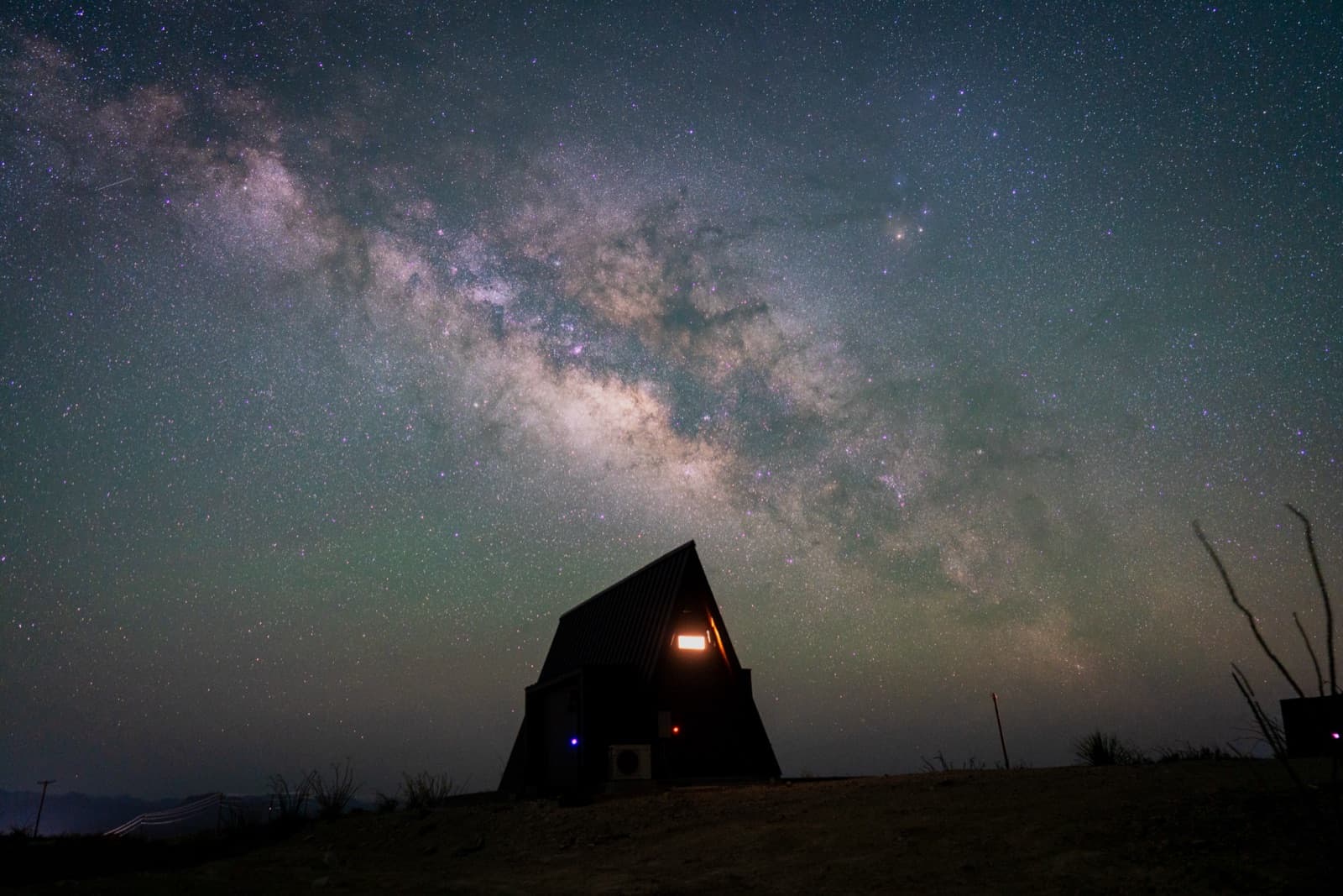Milky Way over an A-frame cabin at Stardust Big Bend in Terlingua, Texas