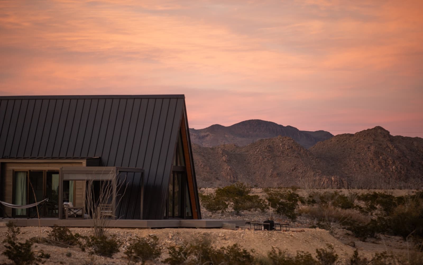 A-Frame #5 cabin at sunset with the mountains of Big Bend, Terlingua Texas
