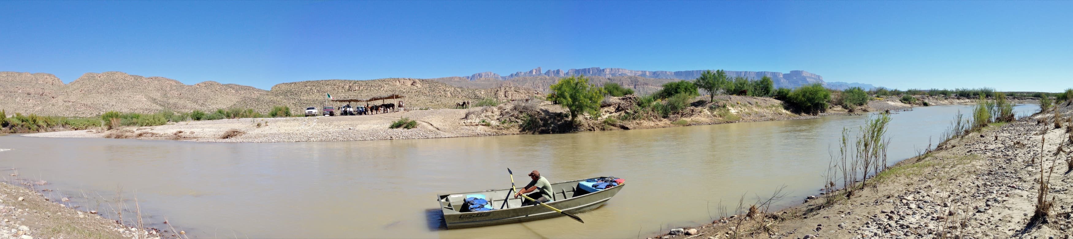Rowboat ferrying a passenger across the Rio Grande at the Boquillas border crossing, Big Bend National Park