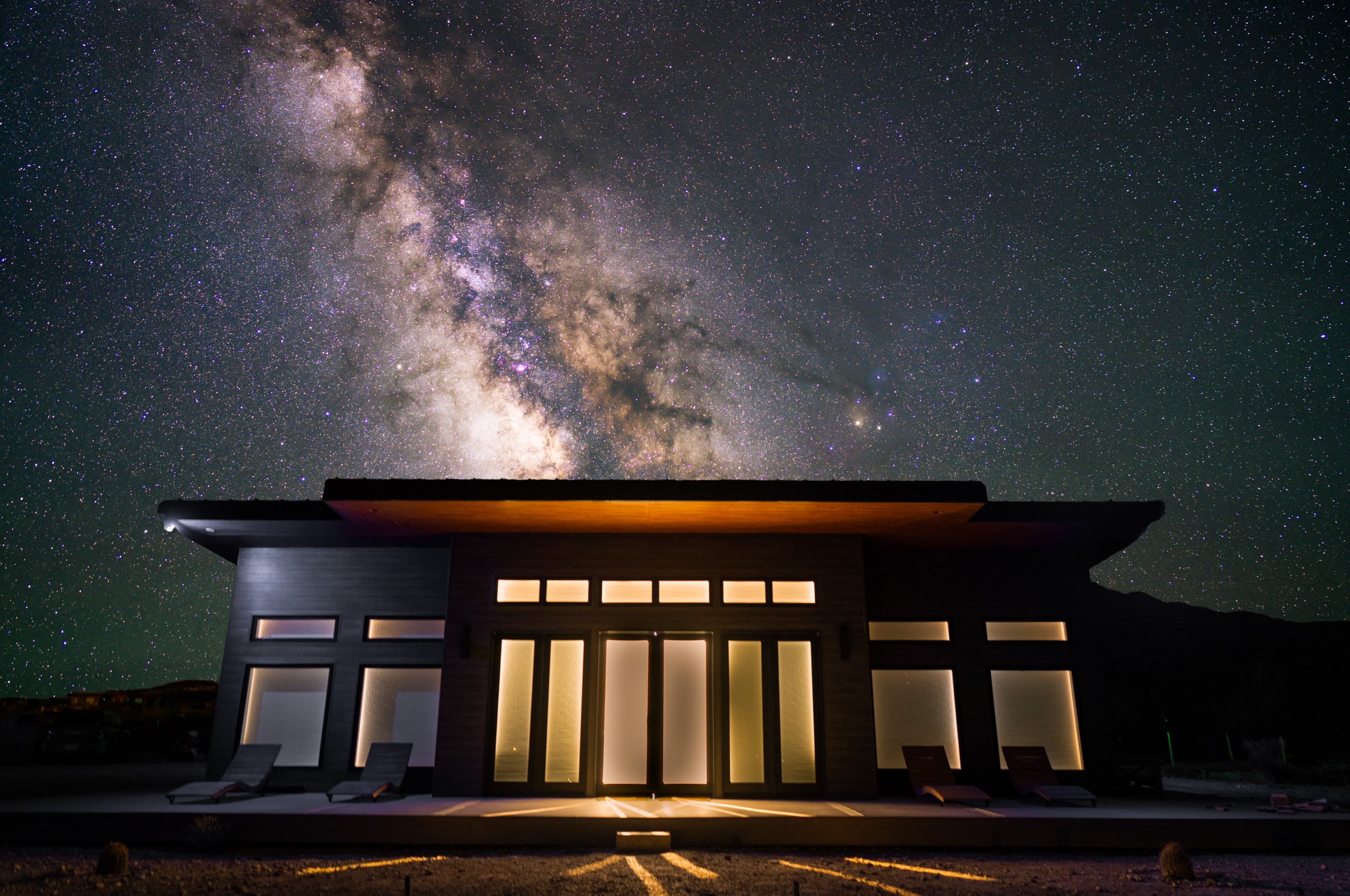 The Stardust clubhouse lit up under the Milky Way